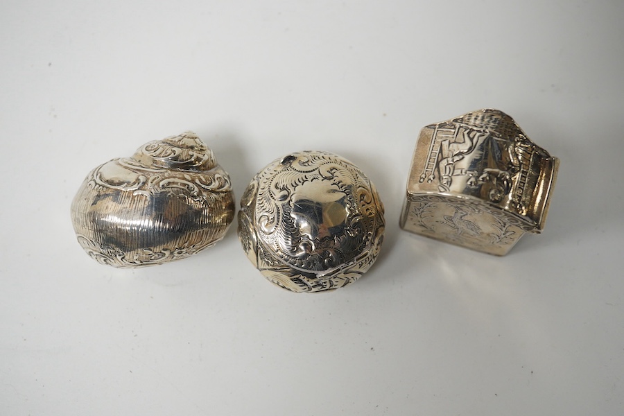 Three small silver boxes, including late Victorian modelled as a snail shell, import marks for London, 1898?, one modelled as a miniature cabinet, makers mark only and a late Victorian circular pill box. Condition - fair